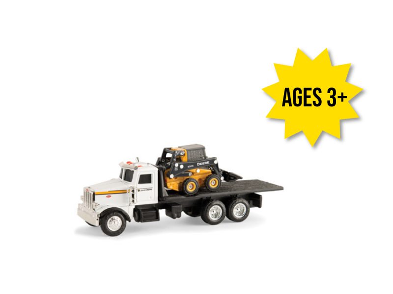 Image of the 1/64 scale John Deere Replica Play 320E Skid Steer on the bed of a Semi truck toy play set.