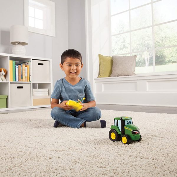 Image of a child playing with the John Deere Remote Control Johnny Tractor kids toy.