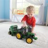 Image of a child playing with the 1/16 scale John Deere Big Farm Tractor and Baler kids toy set.