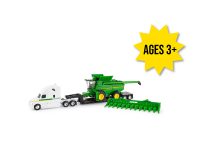 Image of the 1/64 scale white replica toy Semi Truck featuring John Deere stickers and black lowboy trailer with a John Deere S780 combine on it and folding corn head.
