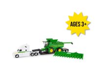Image of the 1/64 scale white replica toy Semi Truck featuring John Deere stickers and black lowboy trailer with a John Deere S780 combine on it and folding corn head.