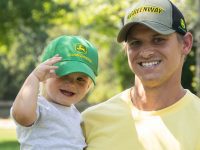 Image of a father holding a child wearing LP78671 the John Deere Mini Me Toddler Baseball Cap.