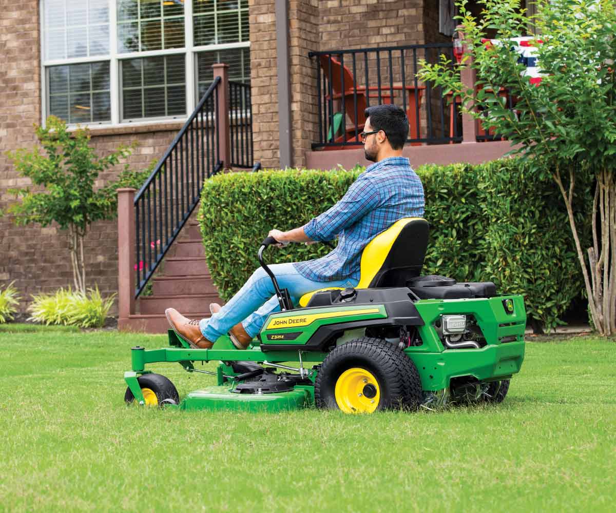 John-Deere-Z325E-Z-Trak-Residental-Zero-Turn-Mower-7 Image of man mowing with Z325E John Deere zero turn mower