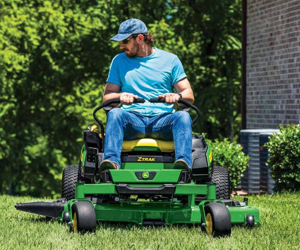 Image of man mowing with a John Deere Z330R zero turn lawn mower