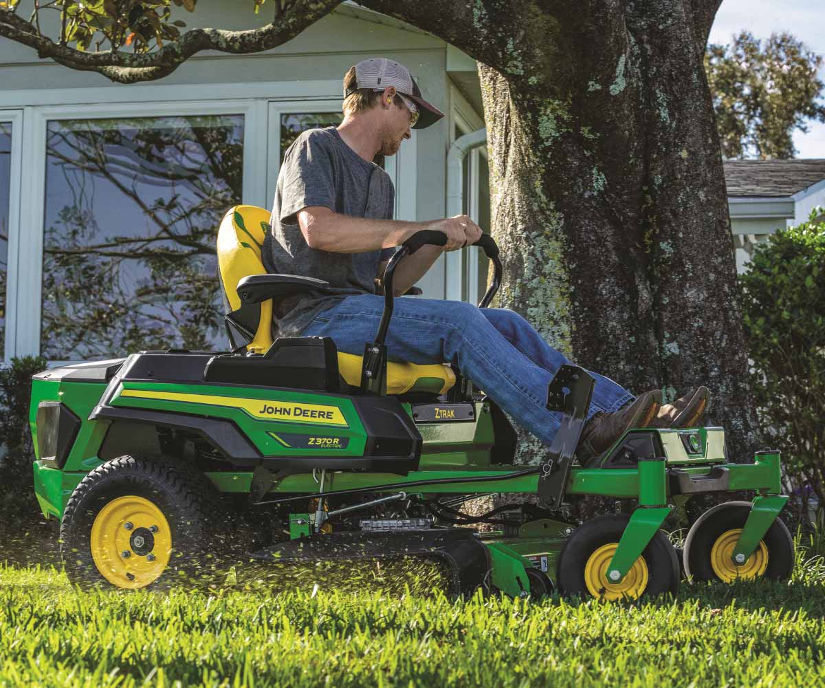 John-Deere-Z370R-Electric-Z-Trak-Mower-25 Image of a person mowing their grass on the John Deere Z370R Electric ZTrak Zero Turn lawn mower.